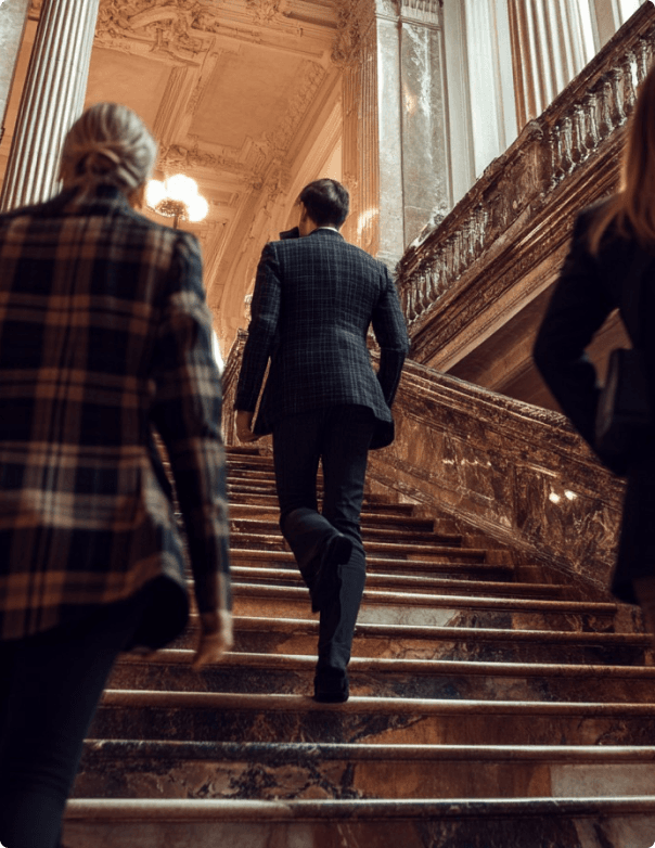 People walking up ornate stairs